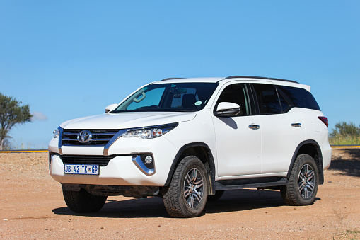 Otjozondjupa Region, Namibia - February 6, 2020: White offroad car Toyota Fortuner at the interurban road.