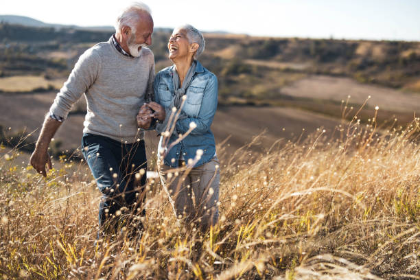 istock Cheerful senior couple talking while walking on a hill in autumn day. 1206782014