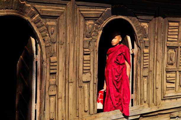 Bagan, Myanmar: Monk at Nat Taung Kyaung wooden monastery Bagan, Myanmar - Nov 16, 2019: Monk at Nat Taung Kyaung wooden monastery in Bagan, Myanmar, former Burma in Asia yoke stock pictures, royalty-free photos & images