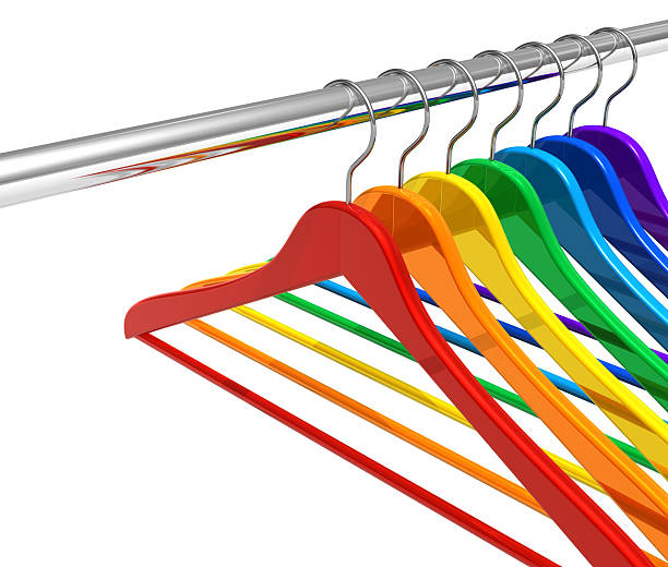 Rainbow hangers on clothes rail Rainbow hangers on metal clothes rail isolated on white background. See also: clothes hanger rod stock pictures, royalty-free photos & images