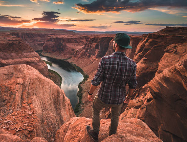 istock man resting at horseshoe bend in usa 1206787324