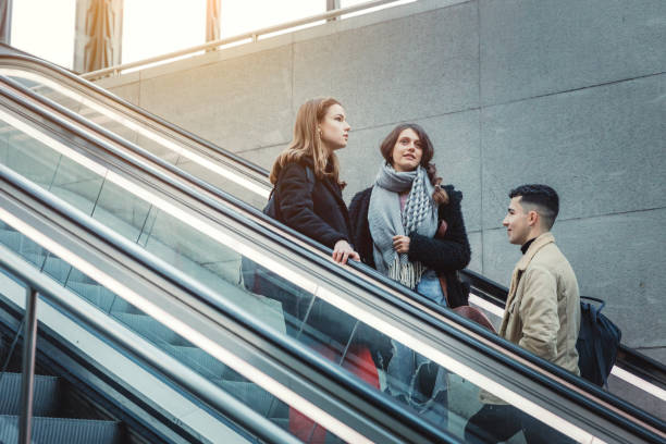 istock Three young people on escalator at subway station 1206787384