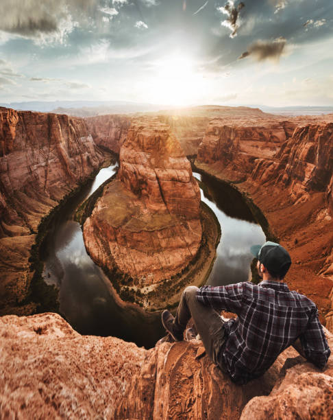 istock man resting at horseshoe bend in usa 1206787608