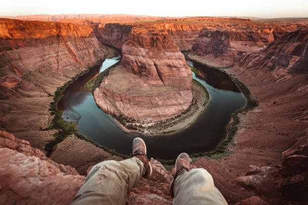 istock man resting at horseshoe bend in usa 1206787641