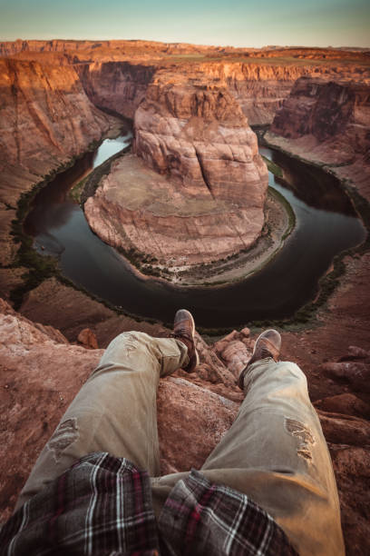 istock man resting at horseshoe bend in usa 1206788322