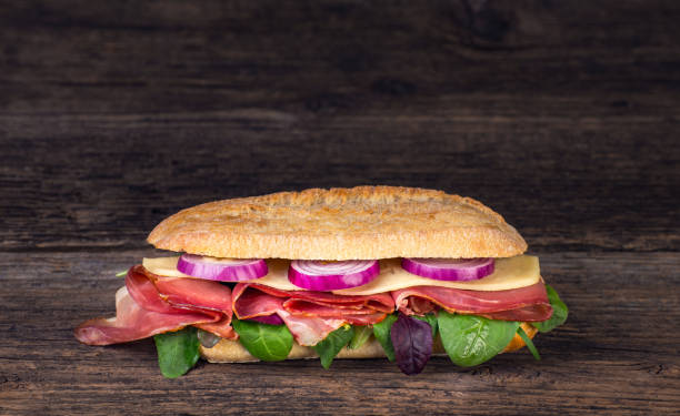 istock Long sandwich with sausage, chees and lettuce 1206788441