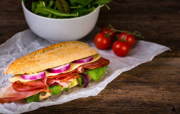 istock Long sandwich with sausage, chees and lettuce 1206788470