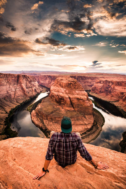 istock man resting at horseshoe bend in usa 1206788476