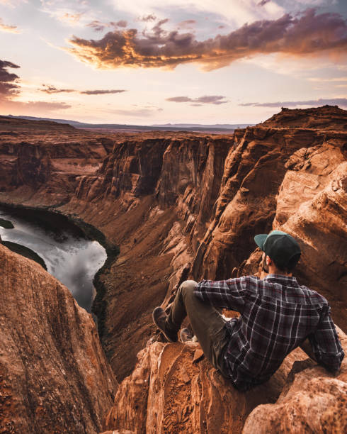 istock man resting at horseshoe bend in usa 1206788515