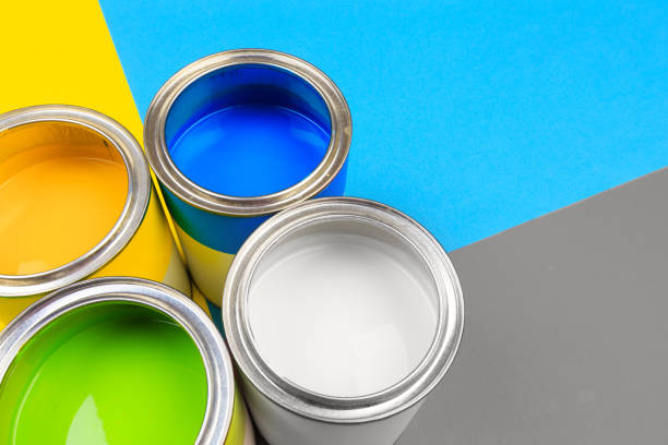istock Metal paint cans and paint brushes on multicolor background. Top view. Copy space. 1206788983