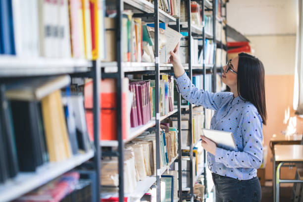istock Portrait of college student studying in the library using tablet PC 1206789037