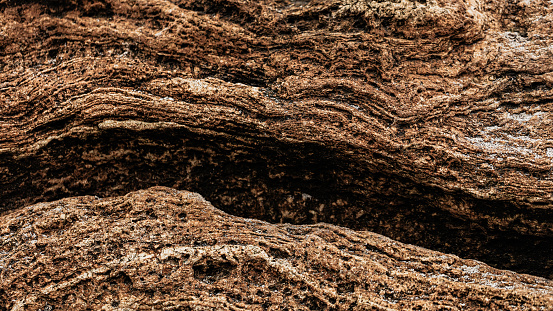 Different texture on the beach - water and sand, stones and pebbles, waves and splashes. Selective focus.