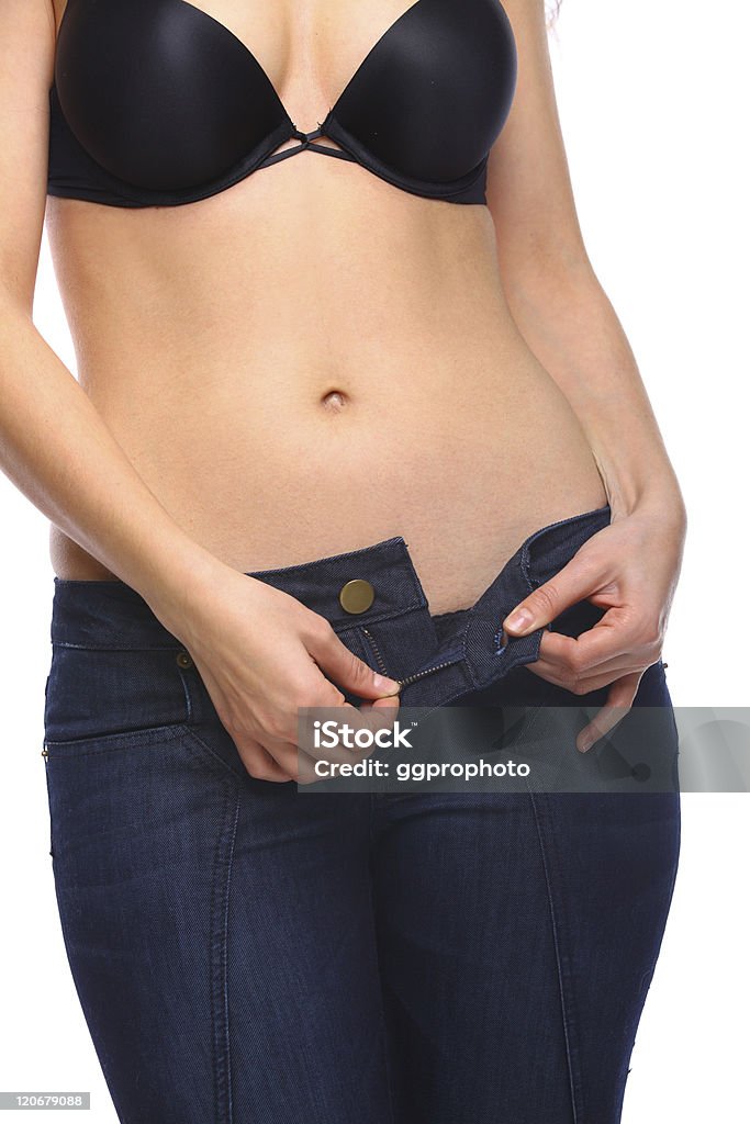 Woman unzipping her pants Sexy woman unzipping her jeans with a bra on Abdomen Stock Photo