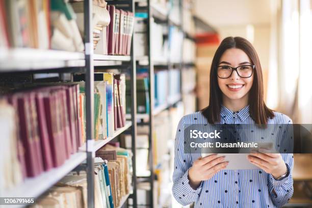 Portrait Of College Student Studying In The Library Using Tablet Pc Stock Photo - Download Image Now