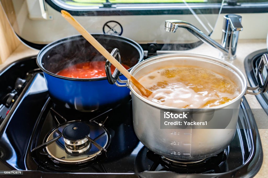 Dinner Cooking On A Small Gas Stove In A Motor Home Stock Photo