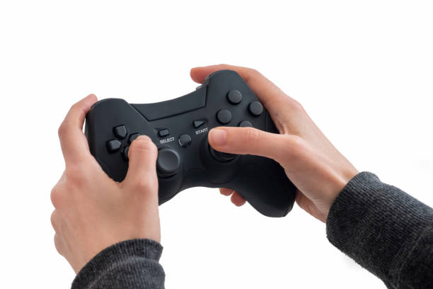 istock Female Hands Holding A Black Joypad, Isolated On White Background 1206794505