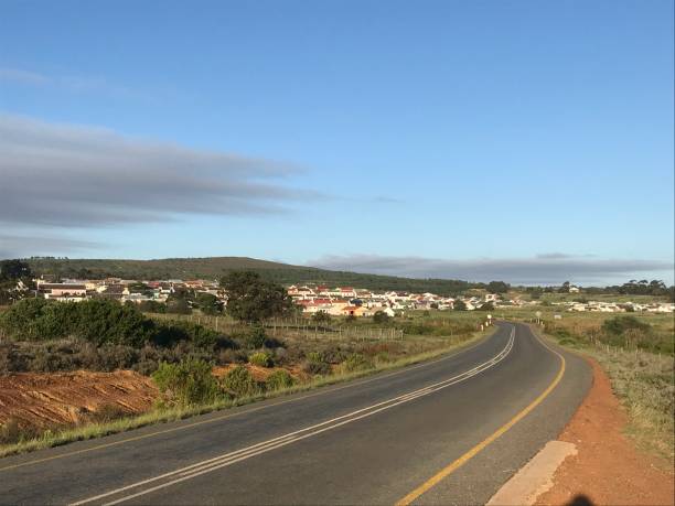 istock Road leading to small town 1206795672