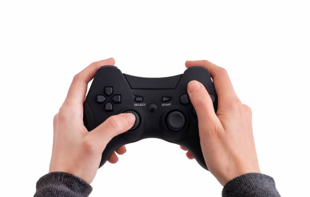 istock Female Hands Holding A Black Joypad, Isolated On White Background 1206797427