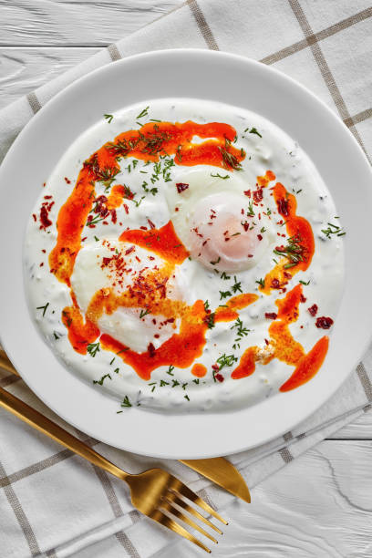 istock cilbir, poached eggs in yogurt sauce topped with spicy butter 1206797824
