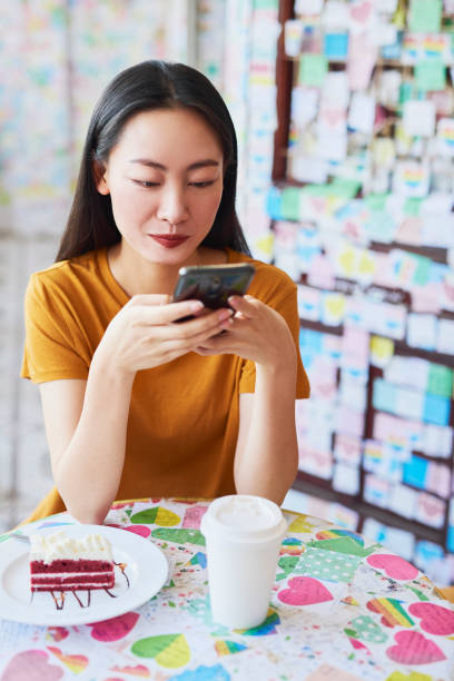 istock Young woman enjoying wireless internet at cafe 1206798502