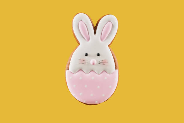 istock Gingerbread cookie in shape of bunny on yellow background 1206798513