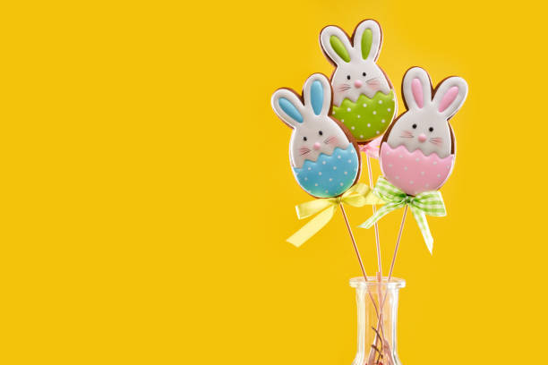 istock Vivid yellow background with easter gingerbreads on sticks 1206798774