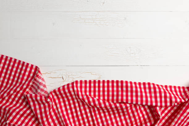 istock Red towel over wooden kitchen table. 1206801858