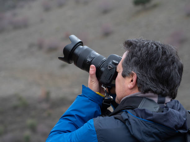 istock Man taking a photograph with a reflex camera and a zoom lens 1206801930