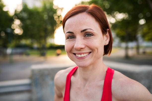 istock Front view of young woman standing outdoors in city, resting after exercise. 1206802003
