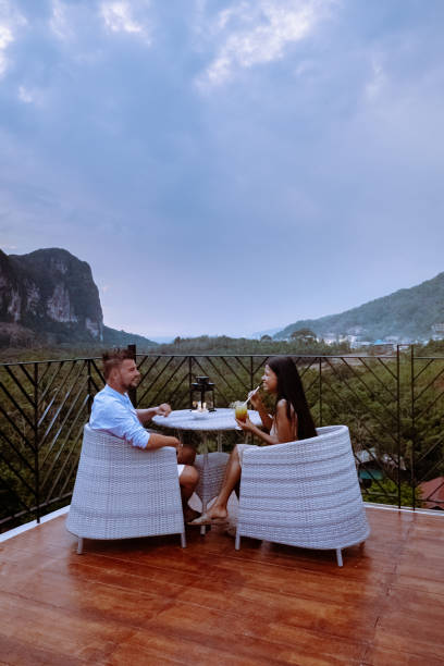 istock couple watching sunset from rooftop bar in Krabi Thailand 1206802144