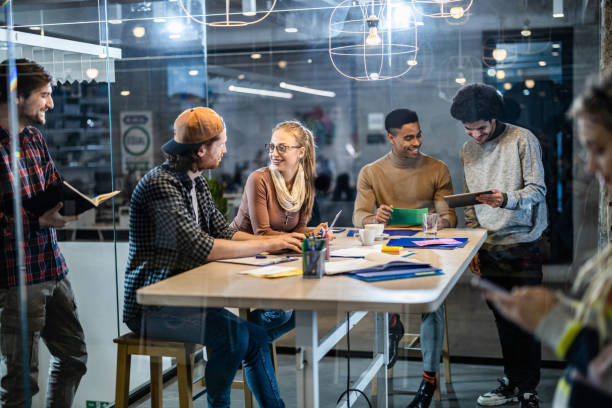 istock Large group of happy multi-tasking freelancers working in the office. 1206802259