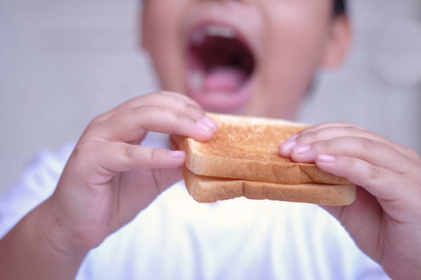 istock A child eating a toast in the morning 1206802589
