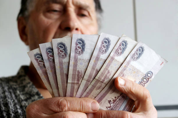 istock Elderly man counts russian rubles in hands 1206804187