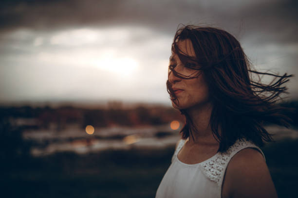 istock Young woman in grass field 1206804997
