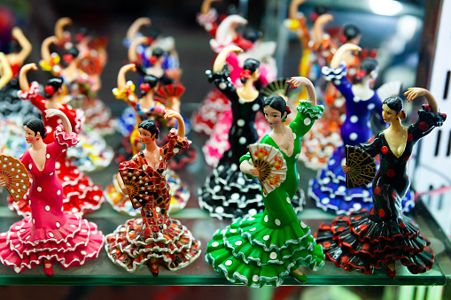 Variety of flamenco dancer figurines on souvenirs stand at market in Spain