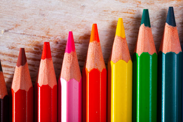 istock Multicolored pencils on wooden background, nobody 1206805110