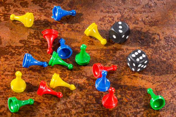 istock game pieces with dice isolated - rusty metal background. 1206806336