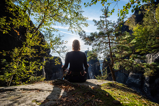 Saxony, Germany: A young woman relaxing after climbing in Saxon Switzerland.