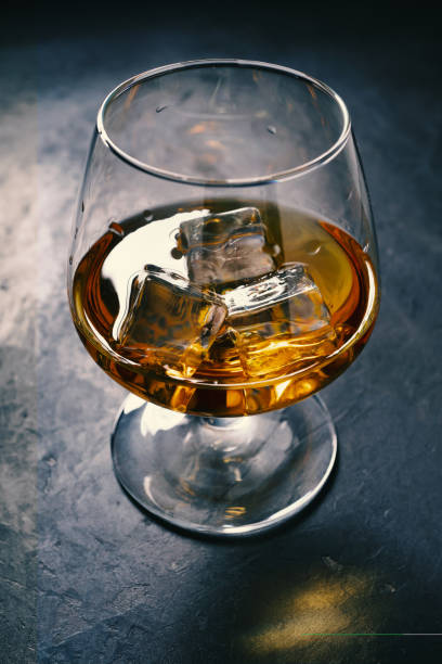 istock concrete table, ice cold, ice cubes, bourbon whiskey, whiskey scotch, shot glass 1206807606
