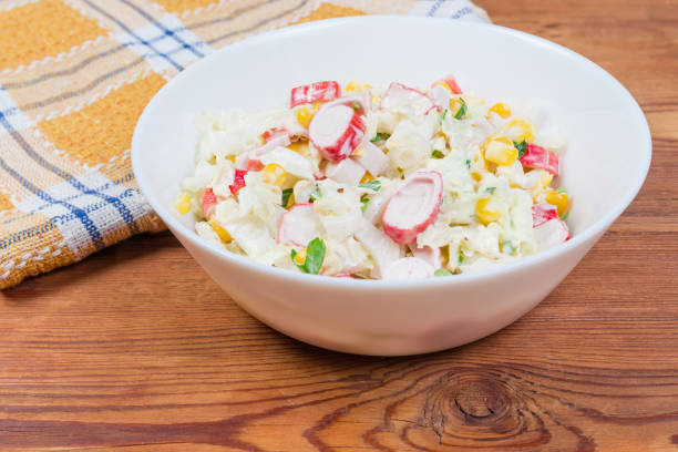 istock Crab sticks salad with vegetables on rustic table close-up 1206808171