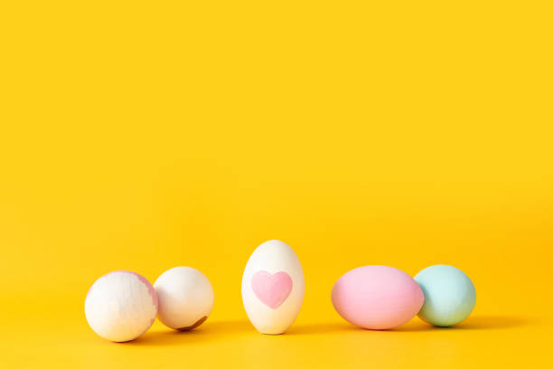 istock Minimal composition of decor eggs on yellow background 1206808298