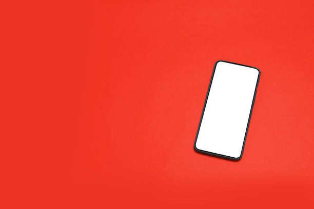 istock Mock up smartphone with blank screen on red background. 1206808370