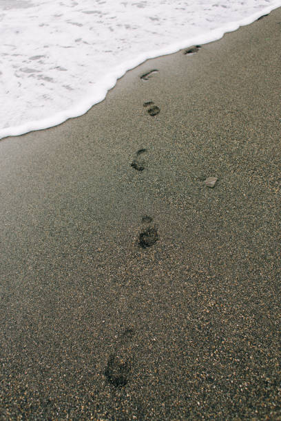 istock footprints on the wet sand from the sea wave on the beach 1206809334