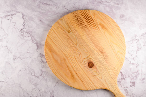 istock Wooden cutting board on a gray marble background 1206809402