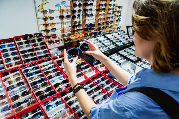 istock Woman chooses sunglasses 1206809839
