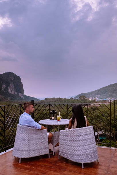 istock couple watching sunset from rooftop bar in Krabi Thailand 1206810053