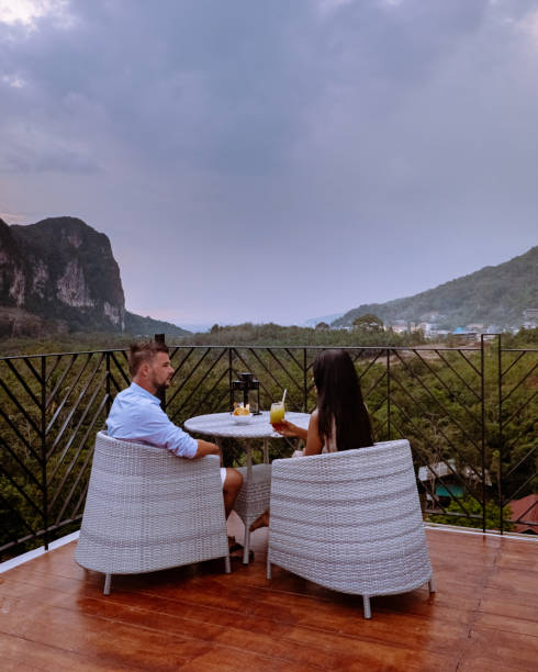 istock couple watching sunset from rooftop bar in Krabi Thailand 1206810610