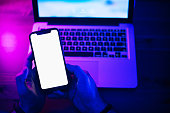 Top view of using smartphone in purple neon light