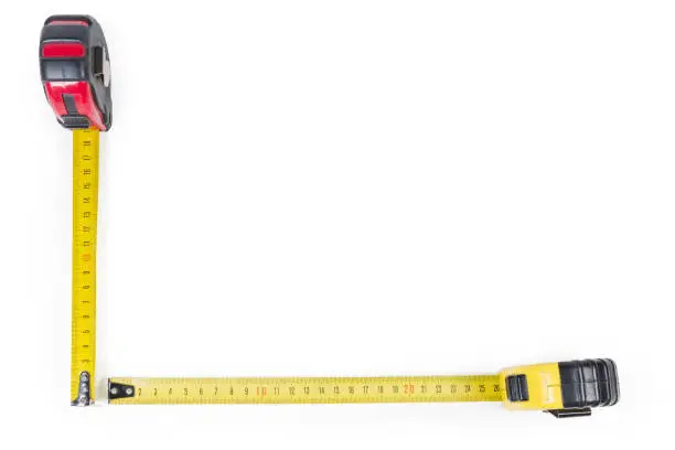Two self-retracting tape measures with flexible rulers with metric scales located bottom and left on a white background with empty the rest of, background