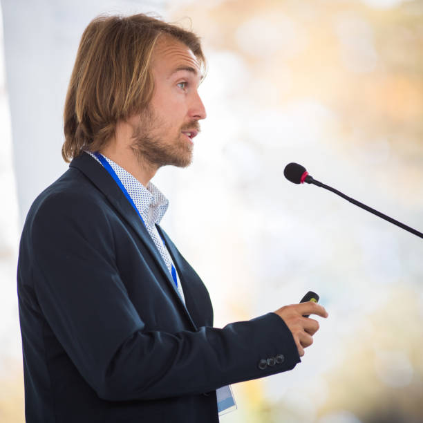 istock Handsome young man giving a speech at a conference 1206813485